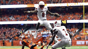 Sep 9, 2016; Syracuse, NY, USA; Louisville Cardinals quarterback Lamar Jackson (8) leaps over Syracuse Orange defensive back Cordell Hudson (20) while running with the ball during the second quarter at the Carrier Dome. Mandatory Credit: Rich Barnes-USA TODAY Sports