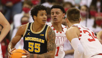Feb 20, 2022; Madison, Wisconsin, USA; Michigan Wolverines guard Eli Brooks (55) looks to pass as Wisconsin Badgers guard Johnny Davis (1) and guard Brad Davison (34) defend at the Kohl Center. Mandatory Credit: Mary Langenfeld-USA TODAY Sports