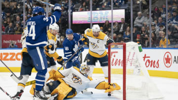 Nov 16, 2021; Toronto, Ontario, CAN Toronto Maple Leafs center Auston Matthews (34) battles as Nashville Predators goaltender Juuse Saros (74) tries to save during the second period at Scotiabank Arena. Mandatory Credit: Nick Turchiaro-USA TODAY Sports