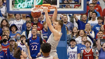 Dec 29, 2021; Lawrence, Kansas, USA; Kansas Jayhawks guard Christian Braun (2) dunks the ball as Nevada Wolf Pack center Will Baker (50) looks on during the first half at Allen Fieldhouse. Mandatory Credit: Denny Medley-USA TODAY Sports