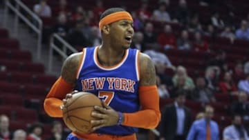 Nov 24, 2014; Houston, TX, USA; New York Knicks forward Carmelo Anthony (7) gets a rebound during the first half against the Houston Rockets at Toyota Center. The Rockets defeated the Knicks 91-86. Mandatory Credit: Troy Taormina-USA TODAY Sports