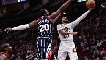 HOUSTON, TEXAS - JANUARY 26: Darius Garland #10 of the Cleveland Cavaliers drives to the basket past Bruno Fernando #20 of the Houston Rockets for a layup during the fourth quarter of the game at Toyota Center on January 26, 2023 in Houston, Texas. NOTE TO USER: User expressly acknowledges and agrees that, by downloading and or using this photograph, User is consenting to the terms and conditions of the Getty Images License Agreement. (Photo by Bob Levey/Getty Images)