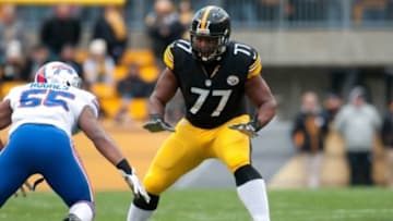 Nov 10, 2013; Pittsburgh, PA, USA; Pittsburgh Steelers tackle Marcus Gilbert (77) prepares to block Buffalo Bills outside linebacker Jerry Hughes (55) during the first quarter of a game at Heinz Field. Pittsburgh won the game 23-10. Mandatory Credit: Mark Konezny-USA TODAY Sports