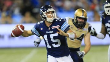 Aug 12, 2014; Toronto, Ontario, Canada; Toronto Argonauts quarterback Ricky Ray (15) passes the football as Winnipeg Blue Bombers defensive lineman Zach Anderson (44) pressures at Rogers Centre. Toronto defeated Winnipeg 38-21. Mandatory Credit: John E. Sokolowski-USA TODAY Sports
