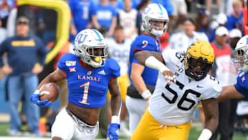 LAWRENCE, KANSAS - SEPTEMBER 21: Running back Pooka Williams Jr. #1 of the Kansas Jayhawks runs against defensive lineman Darius Stills #56 of the West Virginia Mountaineers first quarter at Memorial Stadium on September 21, 2019 in Lawrence, Kansas. (Photo by Ed Zurga/Getty Images)