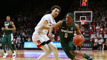 PISCATAWAY, NJ - NOVEMBER 30: Cassius Winston #5 of the Michigan State Spartans drives to the basket as Caleb McConnell #22 of the Rutgers Scarlet Knights defends during the second half of a college basketball game at the Rutgers Athletic Center on November 30, 2018 in Piscataway, New Jersey. Michigan State defeated Rutgers 78-67. (Photo by Rich Schultz/Getty Images,)