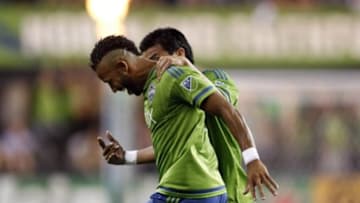 Jul 3, 2015; Seattle, WA, USA; Seattle Sounders FC defender Tyrone Mears (4) celebrates his goal with midfielder Gonzalo Pineda (8) during the second half of a game against D.C. United at CenturyLink Field. Mandatory Credit: Jennifer Buchanan-USA TODAY Sports