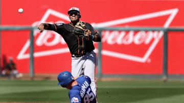 SURPRISE, AZ - MARCH 05: Infielder Miguel Gomez #52 of the San Francisco Giants throws over the sliding Scott Heineman #85 of the Texas Rangers to complete a double play during the second inning of the spring training game at Surprise Stadium on March 5, 2018 in Surprise, Arizona. (Photo by Christian Petersen/Getty Images)
