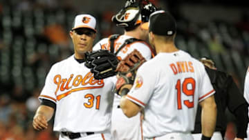 Aug 30, 2016; Baltimore, MD, USA; Baltimore Orioles pitcher Ubaldo Jimenez (31) is congratulated by first baseman Chris Davis (19) after being removed from the game in the seventh inning against the Toronto Blue Jays at Oriole Park at Camden Yards. Mandatory Credit: Evan Habeeb-USA TODAY Sports