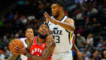 SALT LAKE CITY, UT - OCTOBER 02: Lorenzo Brown (4) of the Toronto Raptors attempts to drive under Tony Bradley (13) of the Utah Jazz during a game at Vivint Smart Home Arena on October 2, 2018 in Salt Lake City, Utah. NOTE TO USER: User expressly acknowledges and agrees that, by downloading and or using this photograph, User is consenting to the terms and conditions of the Getty Images License Agreement. Mandatory Copyright Notice: Copyright 2018 NBAE (Photo by Alex Goodlett/Getty Images)