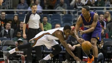 Jan 29, 2014; Milwaukee, WI, USA; Milwaukee Bucks guard Brandon Knight (11) dives for the loose ball as Phoenix Suns forward Channing Frye (8) defends during the first quarter at BMO Harris Bradley Center. Mandatory Credit: Jeff Hanisch-USA TODAY Sports