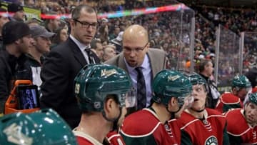 Jan 14, 2014; Saint Paul, MN, USA; Minnesota Wild head coach Mike Yeo and Minnesota Wild assistant coach Daryl Sydor against the Ottawa Senators at Xcel Energy Center. The Senators defeated the Wild 3-0. Mandatory Credit: Brace Hemmelgarn-USA TODAY Sports