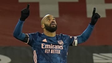 Arsenal's French striker Alexandre Lacazette celebrates after scoring their third goal during the English Premier League football match between Sheffield United and Arsenal at Bramall Lane in Sheffield, northern England on April 11, 2021. - RESTRICTED TO EDITORIAL USE. No use with unauthorized audio, video, data, fixture lists, club/league logos or 'live' services. Online in-match use limited to 120 images. An additional 40 images may be used in extra time. No video emulation. Social media in-match use limited to 120 images. An additional 40 images may be used in extra time. No use in betting publications, games or single club/league/player publications. (Photo by Tim Keeton / POOL / AFP) / RESTRICTED TO EDITORIAL USE. No use with unauthorized audio, video, data, fixture lists, club/league logos or 'live' services. Online in-match use limited to 120 images. An additional 40 images may be used in extra time. No video emulation. Social media in-match use limited to 120 images. An additional 40 images may be used in extra time. No use in betting publications, games or single club/league/player publications. / RESTRICTED TO EDITORIAL USE. No use with unauthorized audio, video, data, fixture lists, club/league logos or 'live' services. Online in-match use limited to 120 images. An additional 40 images may be used in extra time. No video emulation. Social media in-match use limited to 120 images. An additional 40 images may be used in extra time. No use in betting publications, games or single club/league/player publications. (Photo by TIM KEETON/POOL/AFP via Getty Images)