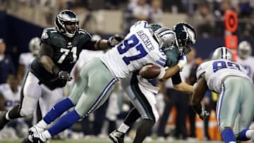 Dec 29, 2013; Arlington, TX, USA; Dallas Cowboys defensive tackle Jason Hatcher (97) hits Philadelphia Eagles quarterback Nick Foles (9) and causes a fumble in the third quarter at AT&T Stadium. Mandatory Credit: Tim Heitman-USA TODAY Sports