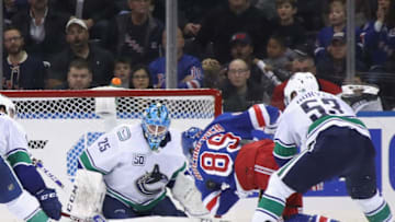 NEW YORK, NEW YORK - OCTOBER 20: Jacob Markstrom #25 of the Vancouver Canucks defends the net against Pavel Buchnevich #89 of the New York Rangers at Madison Square Garden on October 20, 2019 in New York City. The Canucks defeated the Rangers 3-2. (Photo by Bruce Bennett/Getty Images)