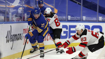 Jan 31, 2021; Buffalo, New York, USA; Buffalo Sabres forward Casey Mittelstadt (37) and New Jersey Devils left wing Jesper Bratt (63) go after a loose puck during the third period at KeyBank Center. Mandatory Credit: Timothy T. Ludwig-USA TODAY Sports