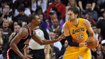 Jan 23, 2014; Miami, FL, USA; Los Angeles Lakers center Pau Gasol (16) is pressured by Miami Heat center Chris Bosh (1) during the second half at American Airlines Arena. Mandatory Credit: Steve Mitchell-USA TODAY Sports