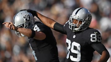 OAKLAND, CA - AUGUST 27: Wide receiver Amari Cooper #89 and quarterback Derek Carr #4 of the Oakland Raiders celebrates after Carr threw a touchdown pass to Cooper against the Tennessee Titans in the first half of their preseason football game at the Oakland Coliseum on August 27, 2016 in Oakland, California. (Photo by Thearon W. Henderson/Getty Images)