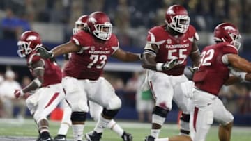 Sep 26, 2015; Arlington, TX, USA; Arkansas Razorbacks guard Sebastian Tretola (73) in action with tackle Jeremiah Levbetter (55) against the Texas A&M Aggies at AT&T Stadium. Mandatory Credit: Matthew Emmons-USA TODAY Sports