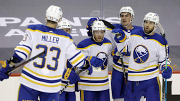 May 6, 2021; Pittsburgh, Pennsylvania, USA; Buffalo Sabres teammates congratulate center Drake Caggiula (91) on his second goal of the game against the Pittsburgh Penguins during the second period at PPG Paints Arena. Mandatory Credit: Charles LeClaire-USA TODAY Sports