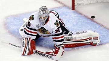 Jun 19, 2013; Boston, MA, USA; Chicago Blackhawks goalie Corey Crawford (50) reacts after giving up a goal to Boston Bruins center Patrice Bergeron (not pictured) during the third period in game four of the 2013 Stanley Cup Final at TD Garden. Mandatory Credit: Greg M. Cooper-USA TODAY Sports