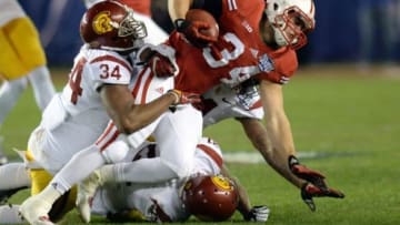 Dec 30, 2015; San Diego, CA, USA; Wisconsin Badgers fullback Derek Watt (34) is tackled by USC Trojans linebacker Olajuwon Tucker (34) during the first quarter in the 2015 Holiday Bowl at Qualcomm Stadium. Mandatory Credit: Jake Roth-USA TODAY Sports