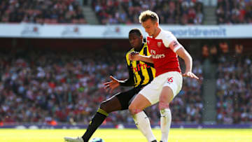 LONDON, ENGLAND - SEPTEMBER 29: Abdoulaye Doucoure of Watford challenges for the ball with Rob Holding of Arsenal during the Premier League match between Arsenal FC and Watford FC at Emirates Stadium on September 29, 2018 in London, United Kingdom. (Photo by Catherine Ivill/Getty Images)