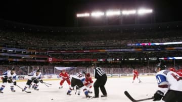 Feb 27, 2016; Denver, CO, USA; Colorado Avalanche center Nathan MacKinnon (29) takes a face off against Detroit Red Wings center Luke Glendening (41) in the first period during a Stadium Series hockey game at Coors Field. Mandatory Credit: Isaiah J. Downing-USA TODAY Sports