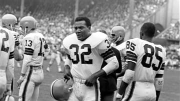 CLEVELAND, OH - NOVEMBER 15, 1964: Runningback Jim Brown #32 of the Cleveland Browns awaits the next series of plays for the offense during a game on November 15, 1964 against the Detroit Lions at Municipal Stadium in Cleveland, Ohio. Also pictured for the Bowns include Frank Ryan #13 and Clifton McNeil #85. 64-71385 (Photo by: Herman Seid Collection/Diamond Images/Getty Images)