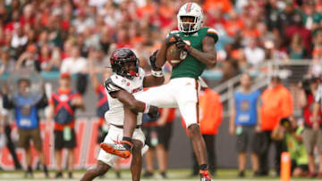 MIAMI, FLORIDA - NOVEMBER 09: Dee Wiggins #8 of the Miami Hurricanes catches a touchdown pass against the Louisville Cardinals during the first half at Hard Rock Stadium on November 09, 2019 in Miami, Florida. (Photo by Michael Reaves/Getty Images)