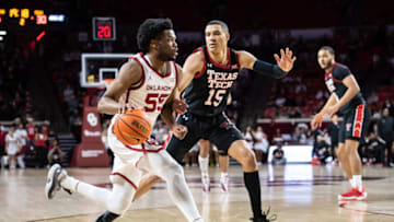 Feb 9, 2022; Norman, Oklahoma, USA; Oklahoma Sooners guard Elijah Harkless (55) moves to the basket while defended by Texas Tech Red Raiders guard Kevin McCullar (15) during the second half at Lloyd Noble Center. Mandatory Credit: Rob Ferguson-USA TODAY Sports