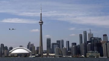 Jul 9, 2015; Toronto, Ontario, Canada; A plane takes off from Billy Bishop City Airport in front of the Toronto skyline in preparation for the 2015 Pan Am Games. Mandatory Credit: John David Mercer-USA TODAY Sports