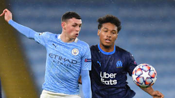 Manchester City's English midfielder Phil Foden (L) vies with Marseille's French defender Boubacar Kamara. (Photo by PAUL ELLIS/AFP via Getty Images)