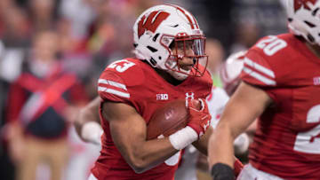 INDIANAPOLIS, IN - DECEMBER 02: Wisconsin Badgers running back Jonathan Taylor (23) looks for a opening in the line during the Big 10 Championship game between the Wisconsin Badgers and Ohio State Buckeyes on December 2, 2017, at Lucas Oil Stadium in Indianapolis, IN. (Photo by Zach Bolinger/Icon Sportswire via Getty Images)