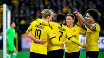 (L-R) Dortmund's German forward Julian Brandt, English forward Jadon Sancho, Belgian forward Thorgan Hazard and Belgian midfielder Axel Witsel congratulate forward Erling Braut Haaland (hidden) after scoring during the German first division Bundesliga football match Borussia Dortmund vs FC Union Berlin in Dortmund on February 1, 2020. (Photo by INA FASSBENDER / AFP) / RESTRICTIONS: DFL REGULATIONS PROHIBIT ANY USE OF PHOTOGRAPHS AS IMAGE SEQUENCES AND/OR QUASI-VIDEO (Photo by INA FASSBENDER/AFP via Getty Images)