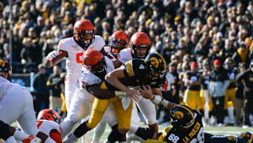 Nov 23, 2019; Iowa City, IA, USA; Iowa Hawkeyes quarterback Nate Stanley (4) in action as Illinois Fighting Illini defensive lineman Jamal Milan (55) and Illinois Fighting Illini defensive lineman Owen Carney Jr. (99) moves in for the tackle at Kinnick Stadium. Mandatory Credit: Jeffrey Becker-USA TODAY Sports