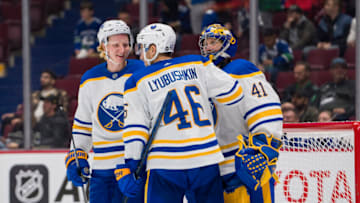 Oct 22, 2022; Vancouver, British Columbia, CAN; Buffalo Sabres defenseman Rasmus Dahlin (26) and defenseman Ilya Lyubushkin (46) and goalie Craig Anderson (41) celebrate their victory against the Vancouver Canucks in the third period at Rogers Arena. Buffalo won 5-1. Mandatory Credit: Bob Frid-USA TODAY Sports
