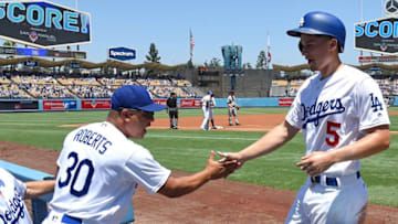 LOS ANGELES, CA - JULY 29: Corey Seager #5 of the Los Angeles Dodgers is greeted in the dugout by manager Dave Roberts after scoring a run in the first inning of the game against the San Francisco Giants at Dodger Stadium on July 29, 2017 in Los Angeles, California. (Photo by Jayne Kamin-Oncea/Getty Images)