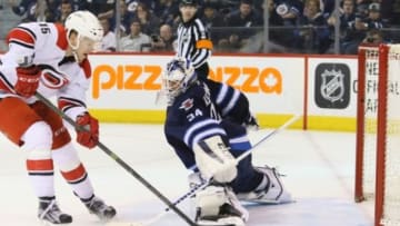 Feb 5, 2016; Winnipeg, Manitoba, CAN; Winnipeg Jets goalie Michael Hutchinson (34) is scored on by Carolina Hurricanes right wing Andrej Nestrasil (15) during the third period at MTS Centre. Carolina won 5-3. Mandatory Credit: Bruce Fedyck-USA TODAY Sports