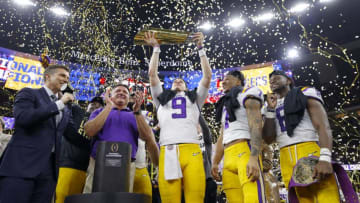 NEW ORLEANS, LOUISIANA - JANUARY 13: Head coach Ed Orgeron of the LSU Tigers, Joe Burrow #9 of the LSU Tigers and Grant Delpit #7 of the LSU Tigers celebrate with the trophy after defeating the Clemson Tigers 42-25 in the College Football Playoff National Championship game at Mercedes Benz Superdome on January 13, 2020 in New Orleans, Louisiana. (Photo by Kevin C. Cox/Getty Images)
