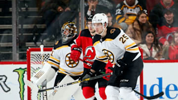 NEWARK, NJ - DECEMBER 31: Brandon Carlo #25 of the Boston Bruins defends against Nico Hischier #13 of the New Jersey Devils during an NHL hockey game on December 31, 2019 at the Prudential Center in Newark, New Jersey. Devils won 3-2 in a shootout. (Photo by Paul Bereswill/Getty Images)