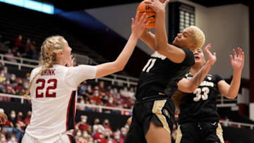 Feb 13, 2022; Stanford, California, USA; Colorado Buffaloes center Quay Miller (11) grabs a rebound over Stanford Cardinal forward Cameron Brink (22) during the second quarter at Maples Pavilion. Mandatory Credit: Darren Yamashita-USA TODAY Sports