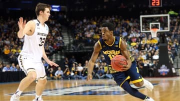 Mar 18, 2016; Brooklyn, NY, USA; Michigan Wolverines guard Derrick Walton Jr. (10) drives to the basket against Notre Dame Fighting Irish guard Steve Vasturia (32) in the first half in the first round of the 2016 NCAA Tournament at Barclays Center. Mandatory Credit: Anthony Gruppuso-USA TODAY Sports