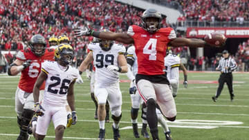 Nov 26, 2016; Columbus, OH, USA; Ohio State Buckeyes running back Curtis Samuel (4) scores the winning touchdown in the second overtime under pursuit from Michigan Wolverines cornerback Jourdan Lewis (26) at Ohio Stadium. Ohio State won the game 30-27 in double overtime.Mandatory Credit: Greg Bartram-USA TODAY Sports