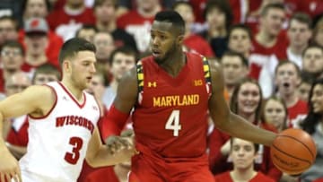Jan 9, 2016; Madison, WI, USA; Maryland Terrapins forward Robert Carter (4) works the ball against Wisconsin Badgers guard Zak Showalter (3) at the Kohl Center. Maryland defeated Wisconsin 63-60. Mandatory Credit: Mary Langenfeld-USA TODAY Sports