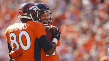 Oct 5, 2014; Denver, CO, USA; Denver Broncos quarterback Peyton Manning (18) celebrates with tight end Julius Thomas (80) after throwing his 500th career touchdown during the first half against the Arizona Cardinals at Sports Authority Field at Mile High. Mandatory Credit: Chris Humphreys-USA TODAY Sports