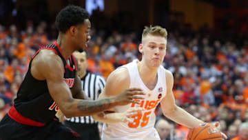 SYRACUSE, NY - FEBRUARY 20: Buddy Boeheim #35 of the Syracuse Orange drives to the basket against the defense of V.J. King #13 of the Louisville Cardinals during the second half at the Carrier Dome on February 20, 2019 in Syracuse, New York. Syracuse defeated Louisville 69-49. (Photo by Rich Barnes/Getty Images)