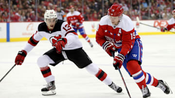 WASHINGTON, DC - NOVEMBER 30: Nicklas Backstrom #19 of the Washington Capitals skates in front of Nico Hischier #13 of the New Jersey Devils during the second period at Capital One Arena on November 30, 2018 in Washington, DC. (Photo by Will Newton/Getty Images)