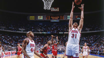 EAST RUTHERFORD, N.J. - 1993: Sam Bowie #31 of the New Jersey Nets rebounds against the Chicago Bulls during a game played circa 1993 at the Brendan Byrne Arena in East Rutherford, New Jersey. NOTE TO USER: User expressly acknowledges and agrees that, by downloading and or using this photograph, User is consenting to the terms and conditions of the Getty Images License Agreement. Mandatory Copyright Notice: Copyright 1993 NBAE (Photo by Nathaniel S. Butler/NBAE via Getty Images)