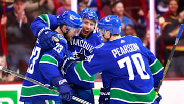 VANCOUVER, BC - MARCH 26: Alexander Edler #23 of the Vancouver Canucks is congratulated by teammates Tanner Pearson #70 and Josh Leivo #17 after scoring during their NHL game against the Anaheim Ducks at Rogers Arena March 26, 2019 in Vancouver, British Columbia, Canada. (Photo by Jeff Vinnick/NHLI via Getty Images)"n